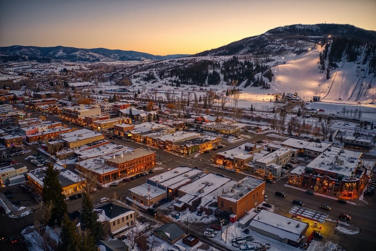 Downtown Steamboat Springs at sunset with ski slopes