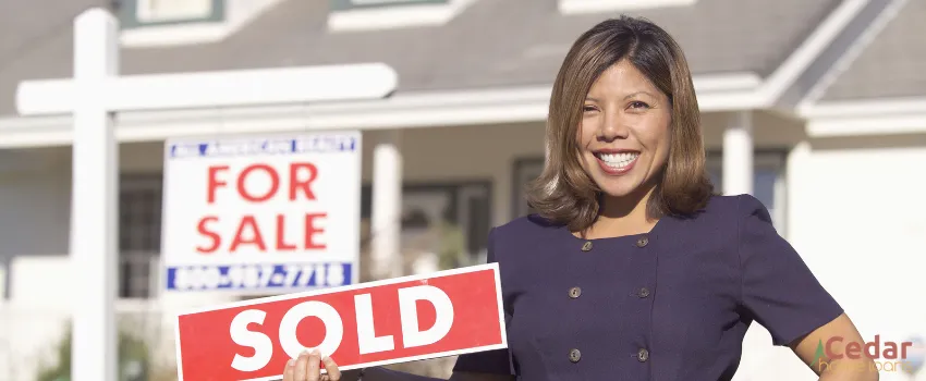 CHL - A real estate agent holding a sold sign